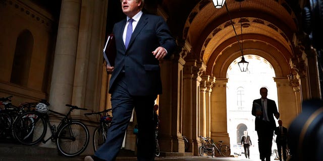 Britain's Prime Minister Boris Johnson walks to his office in Downing Street after a cabinet meeting in London, Tuesday, Sept. 15, 2020.(AP Photo/Frank Augstein)