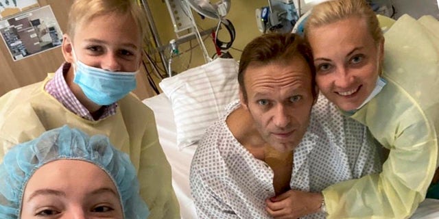This handout photo published by Russian opposition leader Alexei Navalny on his Instagram account shows himself, center, and his wife Yulia, right, daughter Daria, and son Zakhar, top left, posing for a photo in a hospital in Berlin, Germany. (Navalny Instagram via AP)