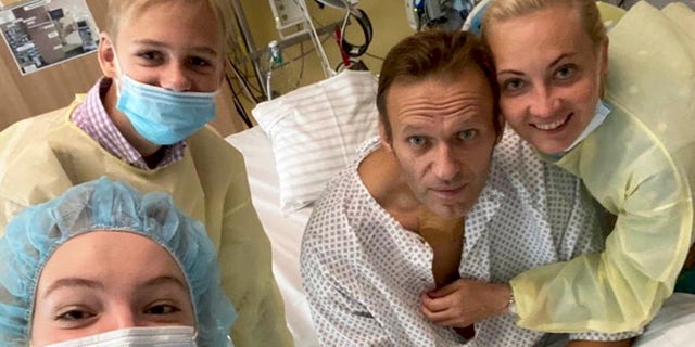 This handout photo published by Russian opposition leader Alexei Navalny on his instagram account, shows himself, centre, and his wife Yulia, right, daughter Daria, and son Zakhar, top left, posing for a photo in a hospital in Berlin, Germany. (Navalny instagram via AP)