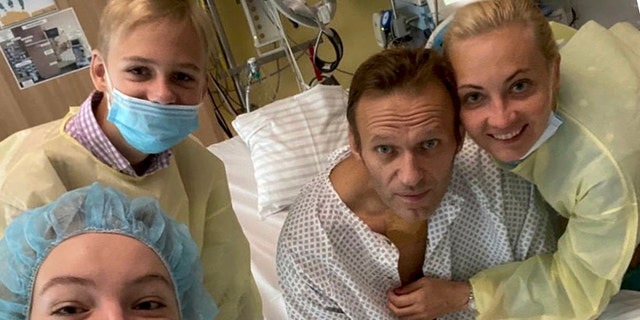 This handout photo, published by Russian opposition leader Alexei Navalny on his instagram account, shows himself, center, and his wife Yulia, right, posing for a photo with medical workers in a hospital in Berlin, Germany. He posted on Instagram Tuesday Sept. 15, 2020: "Hi, this is Navalny. I have been missing you. I still can't do much, but yesterday I managed to breathe on my own for the entire day." (Navalny instagram via AP)