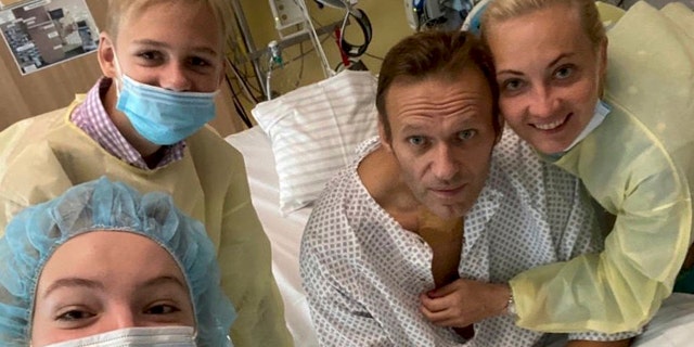 This handout photo, published by Russian opposition leader Alexei Navalny on his instagram account, shows himself, center, and his wife Yulia, right, posing for a photo with medical workers in a hospital in Berlin, Germany. He posted on Instagram Tuesday Sept. 15, 2020: "Hi, this is Navalny. I have been missing you. I still can't do much, but yesterday I managed to breathe on my own for the entire day." (Navalny instagram via AP)