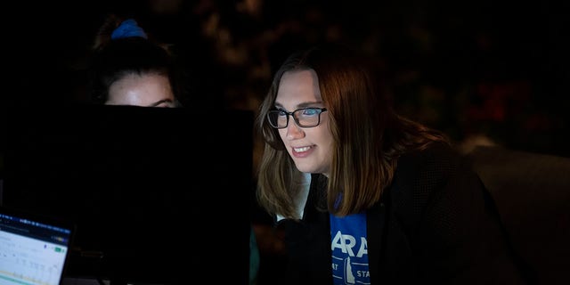Transgender activist Sarah McBride watches a computer screen at her watch party in Wilmington, Del., Tuesday, Sept. 15, 2020. (AP Photo/Jason Minto)