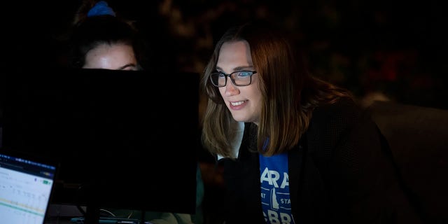 Transgender activist Sarah McBride watches a computer screen at her watch party in Wilmington, Del., Tuesday, Sept. 15, 2020. (AP Photo/Jason Minto)