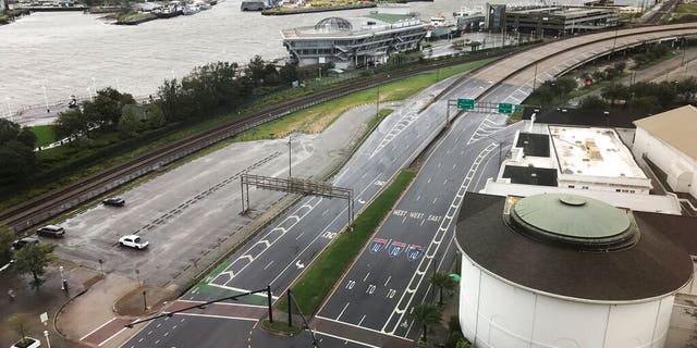 Sparse traffic is seen, Wednesday, Sept. 16, 2020, in downtown Mobile, Ala. Hurricane Sally made landfall Wednesday near Gulf Shores, Alabama, as a Category 2 storm, pushing a surge of ocean water onto the coast and dumping torrential rain that forecasters said would cause dangerous flooding from the Florida Panhandle to Mississippi and well inland in the days ahead.(AP Photo/Angie Wang)
