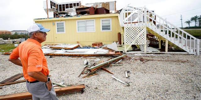 Joe Mirable surveys the damage to his business after Hurricane Sally moved through the area, Wednesday, Sept. 16, 2020, in Perdido Key, Fla. Hurricane Sally made landfall Wednesday near Gulf Shores, Alabama, as a Category 2 storm, pushing a surge of ocean water onto the coast and dumping torrential rain that forecasters said would cause dangerous flooding from the Florida Panhandle to Mississippi and well inland in the days ahead. (AP Photo/Gerald Herbert)