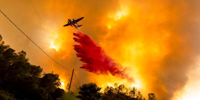 In this Aug. 18 photo, an air tanker drops retardant as the LNU Lightning Complex fires tear through the Spanish Flat community in unincorporated Napa County, Calif. Two unusual weather phenomena combined to create some of the most destructive wildfires the West Coast states have seen in modern times. (AP Photo/Noah Berger, File)