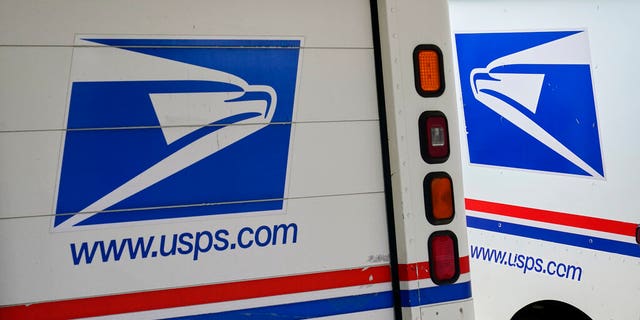 FILE: Mail delivery vehicles are parked outside a post office in Boys Town, Neb. 