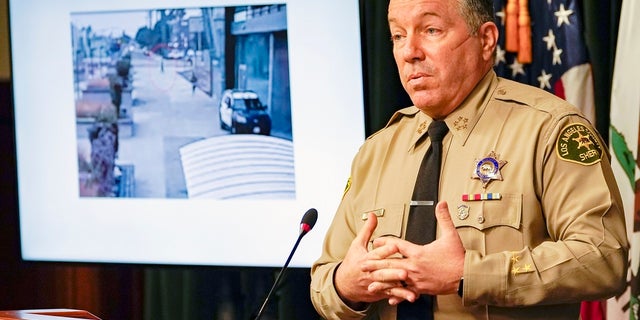 Los Angeles County Sheriff Alex Villanueva comments on the investigation of the shooting of two deputies during a news conference at the Hall of Justice in downtown Los Angeles on Thursday. Investigators are looking to identify a potential witness to the attack, he said. (AP Photo/Damian Dovarganes)