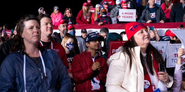 Supporters of President Donald Trump listen as he speaks during a campaign rally at Central Wisconsin Airport, Thursday, Sept. 17, 2020, in Mosinee, Wis. (AP Photo/Evan Vucci)