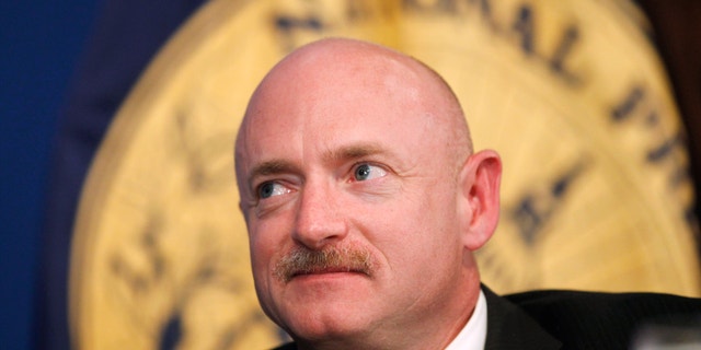 FILE - In this Friday, July 1, 2011, file photo, NASA Space Shuttle astronaut Capt. Mark Kelly, husband of wounded Rep. Gabrielle Giffords, D-Ariz., listens during a luncheon at the National Press Club in Washington. If Arizona Democrat Mark Kelly wins a seat in the U.S. Senate, he could take office as early as Nov. 30, 2020. A Kelly victory would shrink the GOP's Senate majority at a crucial moment and complicate the path to confirmation for President Donald Trump's Supreme Court nominee. (AP Photo/Charles Dharapak, File)