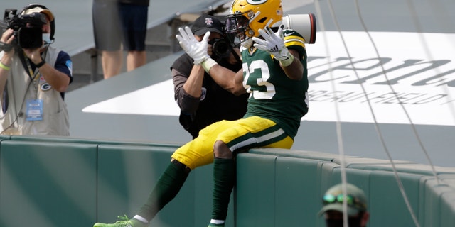 Green Bay Packers' Aaron Jones celebrates his touchdown catch during the first half of an NFL football game against the Detroit Lions Sunday, Sept. 20, 2020, in Green Bay, Wis. (AP Photo/Mike Roemer)
