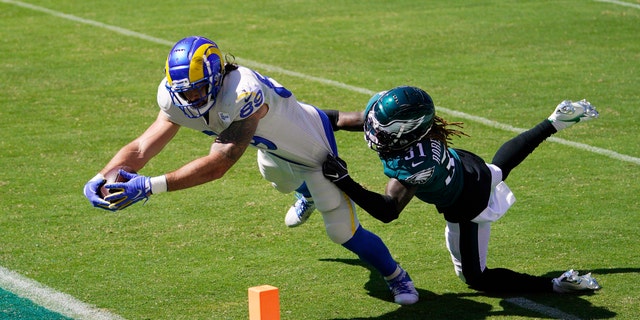 Los Angeles Rams' Tyler Higbee, left, reaches for a touchdown against Philadelphia Eagles' Nickell Robey-Coleman during the first half of an NFL football game, Sunday, Sept. 20, 2020, in Philadelphia. (AP Photo/Chris Szagola)