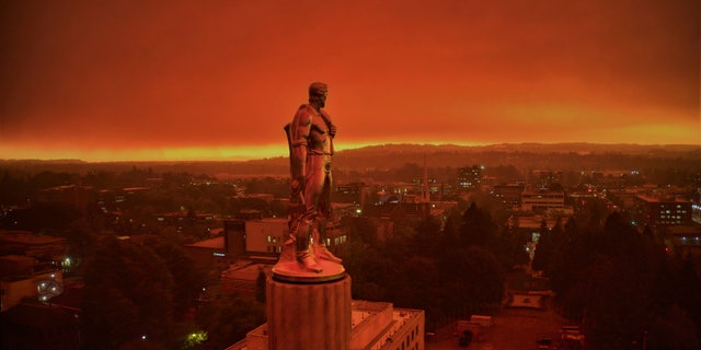 This drone photo provided by Michael Mann shows the Oregon Capitol building, with its "Oregon Pioneer" bronze sculpture atop the dome, as smoke and ash from nearby wildfires cloud skies in Salem, Ore., on Sept. 8, 2020. (Michael Mann via AP)