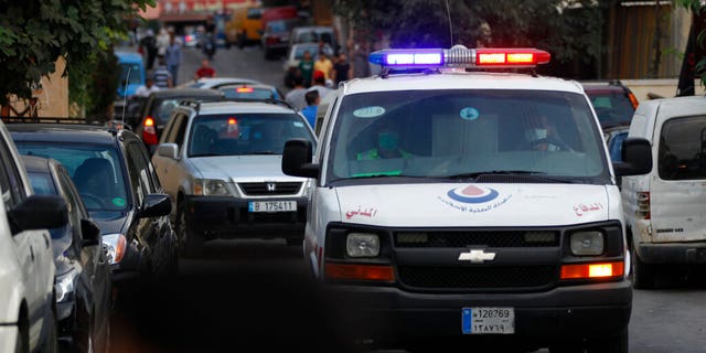 A Hezbollah civil defense ambulance passes on a road that leads to the site of an explosion that rocked a Hezbollah stronghold. (AP Photo/Mohammed Zaatari)
