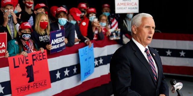 Vice President Mike Pence gives a television interview after a campaign rally, Tuesday, Sept. 22, 2020, at Lanconia Municipal Airport in Gilford, N.H. where he praised the president's "early action" on the coronavirus pandemic. (AP Photo/Robert F. Bukaty)