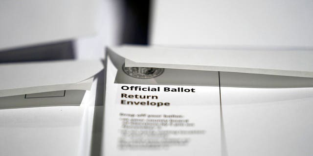 In this Thursday, Sept. 3, 2020, file photo, stacks of ballot envelopes waiting to be mailed are seen at the Wake County Board of Elections in Raleigh, N.C. (AP Photo/Gerry Broome, File)