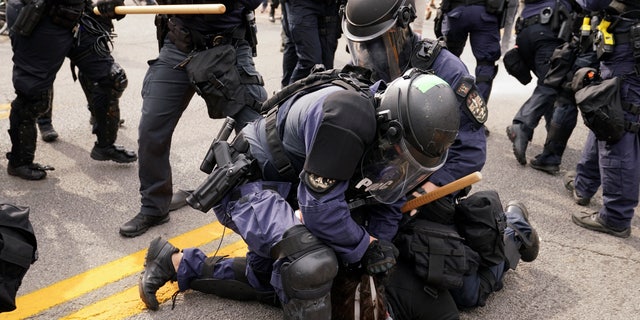 Police detain a protester, Wednesday, Sept. 23, 2020, in Louisville, Ky. (Associated Press)