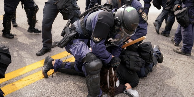 Police detain a protester, Wednesday, Sept. 23, 2020, in Louisville, Ky. (Associated Press)