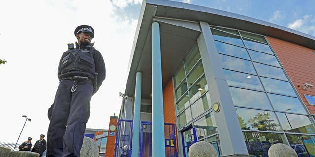 A police officer stands outside Croydon Custody Centre where a police officer was shot in the early hours of Friday, Sept. 25, 2020, in Croydon, England. (Associated Press)