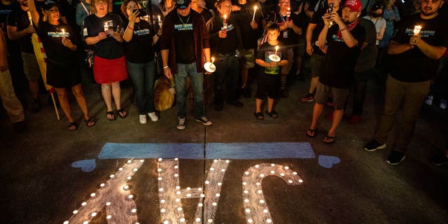 People hold candles during a vigil in Vancouver, Wash., for Aaron "Jay" Danielson, a supporter of Patriot Prayer who was shot and killed in Portland, Ore. (AP Photo/Paula Bronstein, File)