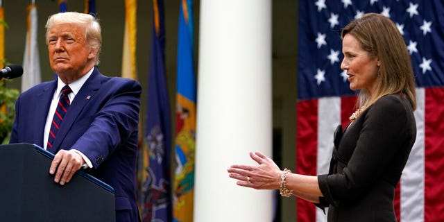 Judge Amy Coney Barrett applauds as President Donald Trump announces Barrett as his nominee to the Supreme Court, in the Rose Garden at the White House, Sept. 26, in Washington. (AP Photo/Alex Brandon)