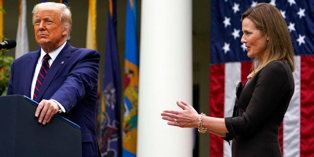 Judge Amy Coney Barrett applauds as President Donald Trump announces Barrett as his nominee to the Supreme Court, in the Rose Garden at the White House, Sept. 26, in Washington. (AP Photo/Alex Brandon)