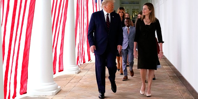 President Donald Trump walks along the Colonnade with Judge Amy Coney Barrett after a news conference to announce Barrett as his nominee to the Supreme Court, in the Rose Garden at the White House, Sept. 26, 2020, in Washington. (Associated Press)