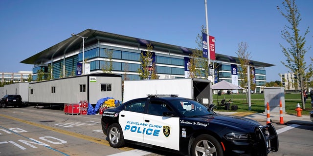 A police cruiser rolls by the Health Education Campus of Case Western Reserve University ahead of the first presidential debate between Republican candidate President Donald Trump and Democratic candidate former Vice President Joe Biden on Tuesday. Some local businesses are boarding up in case riots erupt after the event. (AP Photo / Julio Cortez)