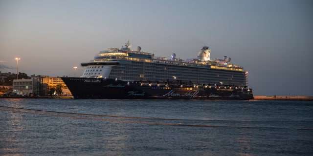 The Mein Schiff 6 cruise ship is docked at Piraeus port, near Athens, early Tuesday, Sept. 29, 2020. Greek authorities say 12 crew members on a Maltese-flagged cruise ship carrying more than 1,500 people on a Greek islands tour have tested positive for coronavirus and have been isolated on board. (AP Photo/Petros Giannakouris)