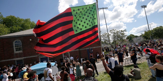 A stylized American Black Lives Matter flag flies during a Juneteenth rally, Friday, June 19, 2020, in Boston. Juneteenth commemorates when the last enslaved African Americans learned in 1865 they were free, more than two years following the Emancipation Proclamation. (AP Photo/Michael Dwyer)