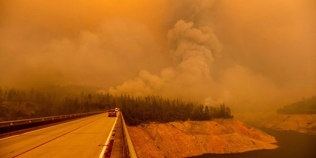 A plume rises from the Bear Fire as it burns along Lake Oroville on Wednesday, Sept. 9, 2020, in Butte County, Calif.