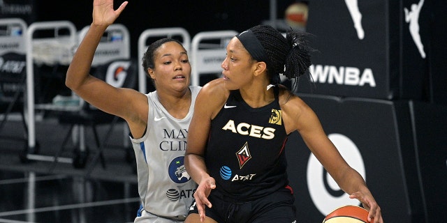 Las Vegas Aces center A'ja Wilson backs into position in front of Minnesota Lynx forward Napheesa Collier during the first half of a WNBA basketball game Thursday, Sept. 10, 2020, in Bradenton, Fla. (AP Photo/Phelan M. Ebenhack)
