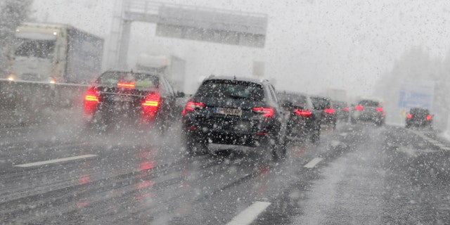 Cars make their way through heavy snow on motorway A 13 in Noesslach near Innsbruck, Austria, Friday, Sept. 25, 2020.