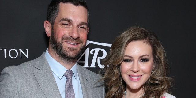 Alyssa Milano (right) and her husband Dave Bugliari (left). The actress said that her husband called the police to ask when they'd be arriving after a neighbor made the initial call to law enforcement. (Photo by Rich Fury/Getty Images)