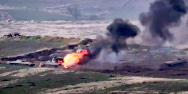 In this image taken from a footage released by Armenian Defense Ministry on Sunday, Sept. 27, 2020, Armenian forces destroy Azerbaijani military vehicle at the contact line of the self-proclaimed Republic of Nagorno-Karabakh, Azerbaijan.