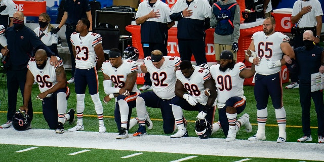 Chicago Bears' Akiem Hicks (96); Kyle Fuller (23); Roy Robertson-Harris (95), Brent Urban (92); Bilal Nichols (98); John Jenkins (90) and Cody Whitehair (65) listen during the national anthem before an NFL football game against the Detroit Lions in Detroit, Sunday, Sept. 13, 2020. (AP Photo/Paul Sancya)