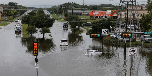 Vehicles are stranded at the intersection of Pearland and South Sam Houston parkways, Tuesday, Sept. 22, 2020, in Houston, following flooding from Tropical Storm Beta.