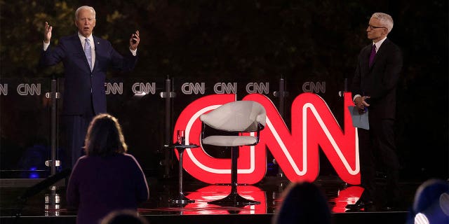 Democratic U.S. presidential nominee and former Vice President Joe Biden kept his distance from CNN host Anderson Cooper until a commercial break. (REUTERS/Jonathan Ernst)