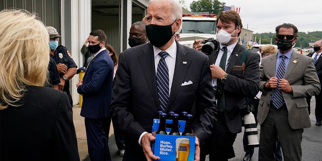 Democratic presidential candidate and former Vice President Joe Biden delivers beer as he and his wife Jill Biden visit the Shanksville Volunteer Fire Department in Shanksville, Pa., Friday, Sept. 11, 2020. The Bidens stopped by after visiting the nearby Flight 93 National Memorial to commemorate the 19th anniversary of the Sept. 11 terrorist attacks. (AP Photo/Patrick Semansky)