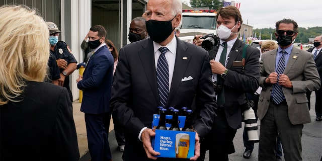 Democratic presidential candidate and former Vice President Joe Biden delivers beer as he and his wife Jill Biden visit the Shanksville Volunteer Fire Department in Shanksville, Pa., Friday, Sept. 11, 2020. The Bidens stopped by after visiting the nearby Flight 93 National Memorial to commemorate the 19th anniversary of the Sept. 11 terrorist attacks. (AP Photo/Patrick Semansky)