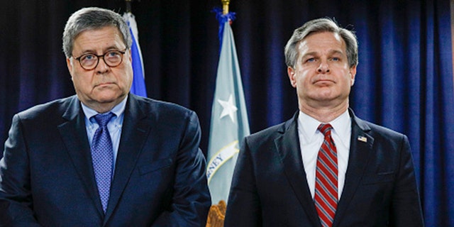 U.S. Attorney General William Barr (left) and FBI Director Christopher Wray stand together at an announcement of a Crime Reduction Initiative designed to reduce crime in Detroit on Dec. 18, 2019, in Detroit, Mich. (Bill Pugliano/Getty Images)