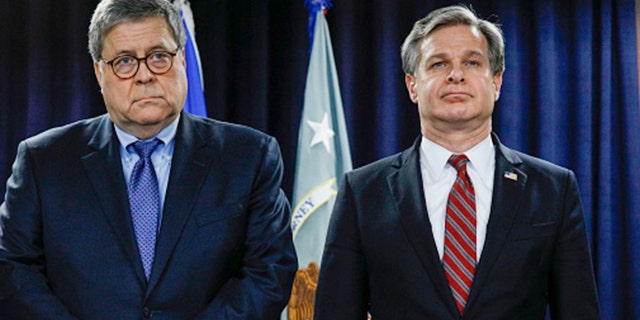 U.S. Attorney General William Barr (left) and FBI Director Christopher Wray stand together at an announcement of a Crime Reduction Initiative designed to reduce crime in Detroit on Dec. 18, 2019, in Detroit, Mich. (Bill Pugliano/Getty Images)