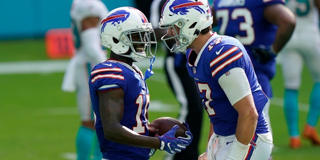 Buffalo Bills quarterback Josh Allen (17) congratulates wide receiver John Brown (15) after Brown scored a touchdown, during the second half of an NFL football game against the Miami Dolphins, Sunday, Sept. 20, 2020, in Miami Gardens, Fla. The Bills defeated the Dolphins 31-28. (AP Photo/Lynne Sladky)
