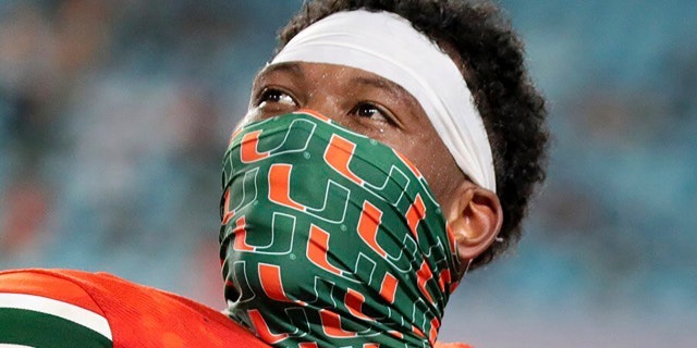 Miami tight end Brevin Jordan (9) and quarterback D'Eriq King (1) display their touchdown rings in the third quarter during an NCAA college football game against UAB in Miami Gardens, Fla., Thursday, Sept. 10, 2020. (Al Diaz/Miami Herald via AP)