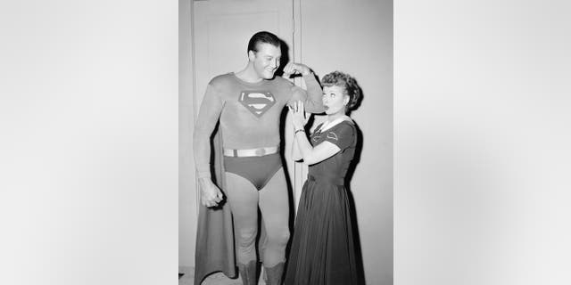 American actor George Reeves (1914-1959) flexes his biceps while actress and comedian Lucille Ball touches his muscle during the episode "Lucy and Superman" in Hollywood, Calif., Nov. 15, 1956.