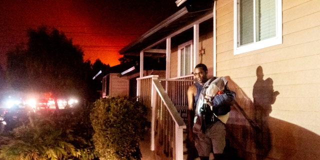 Eddy Whitmore evacuates from his Santa Rosa, Calif., home as the Shady Fire approaches on Sunday, Sept. 27, 2020.