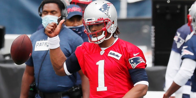 New England Patriots quarterback Cam Newton (1) warms up before an NFL football training camp scrimmage, Friday, Aug. 28, 2020, in Foxborough, Mass. (AP Photo/Michael Dwyer, Pool)