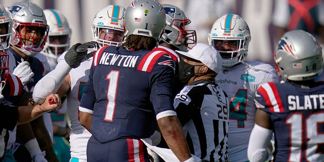 New England Patriots quarterback Cam Newton has words with Miami Dolphins players after an NFL football game, Sunday, Sept. 13, 2020, in Foxborough, Mass. (AP Photo/Charles Krupa)