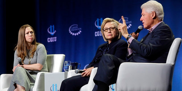 Chelsea Clinton, left, former Secretary of State Hillary Clinton and former President Bill Clinton attend a CGI event on climate change at the University of Chicago in 2018.