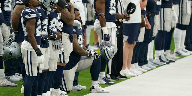 A member of the Dallas Cowboys kneels during the national anthem before an NFL football game against the Los Angeles Rams Sunday, Sept. 13, 2020, in Inglewood, Calif. (AP Photo/Ashley Landis)